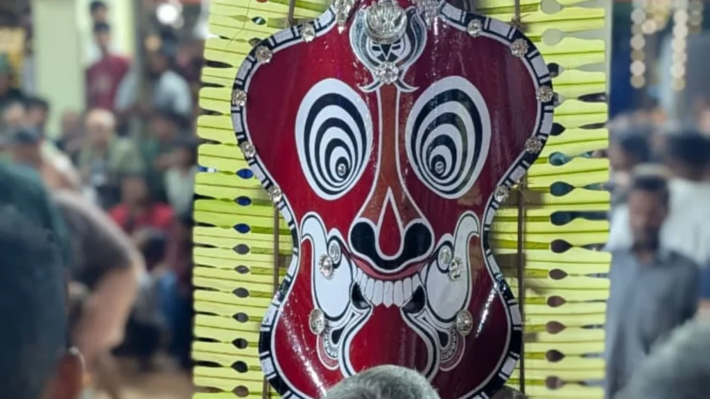 Gulikan Theyyam at Chathampalli Kavu in Kannur, Kerala, featuring the traditional red face paint, large circular headgear and ritual costume
