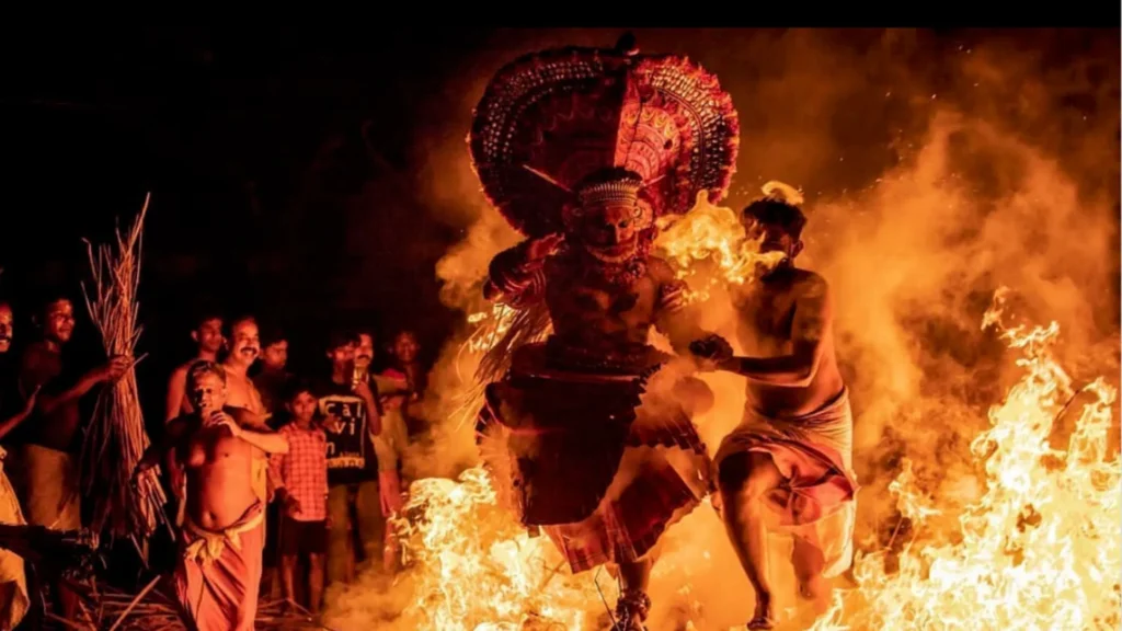 Kandanar Kelan Theyyam jumping through fire at Cherukunnu Kaavu, Kannur`